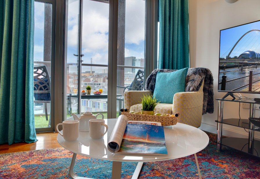 Crown Apartments 4A - comfortable living room with city views from balcony